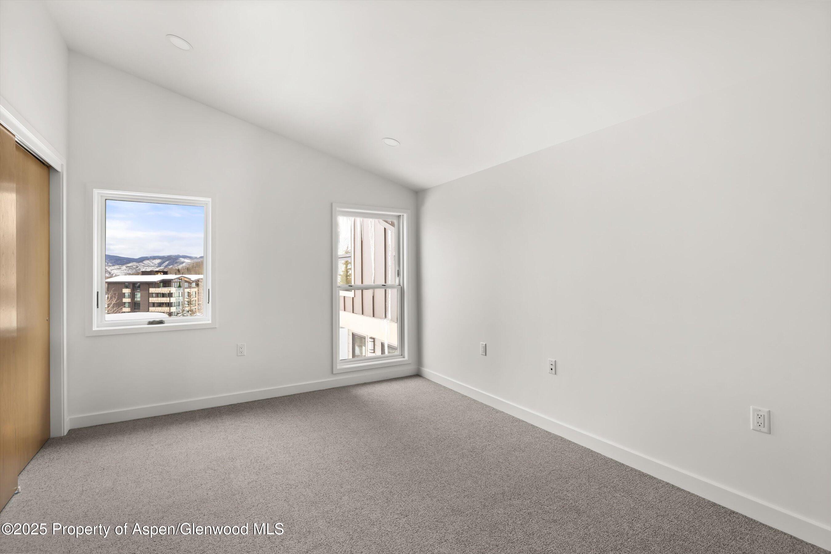 360 Wood Road, Unit 501 Snowmass Village, CO 81615 - Photo 20 of 39 an empty room with windows