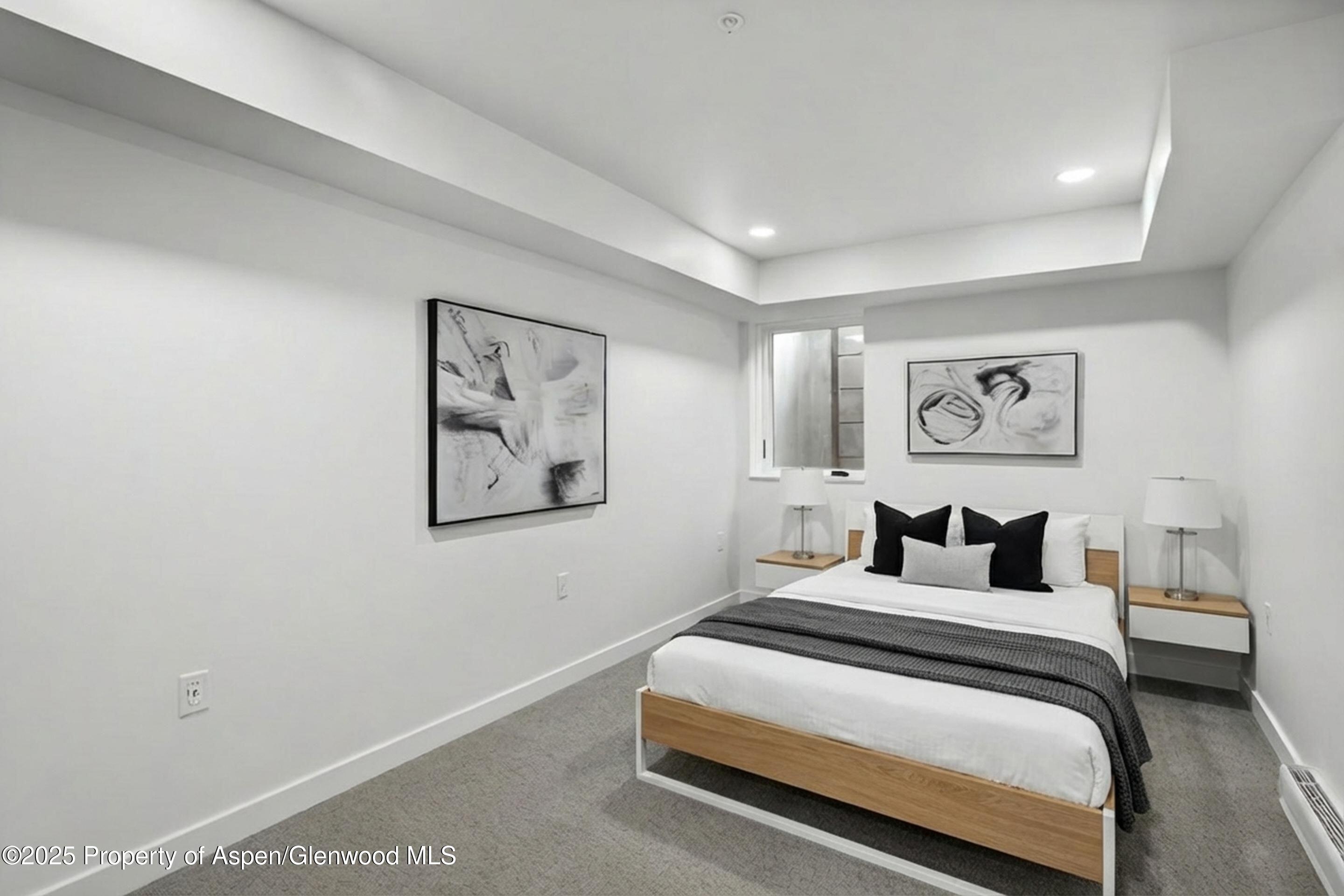 360 Wood Road, Unit 501 Snowmass Village, CO 81615 - Photo 26 of 39 a bedroom with a bed and painting on the wall