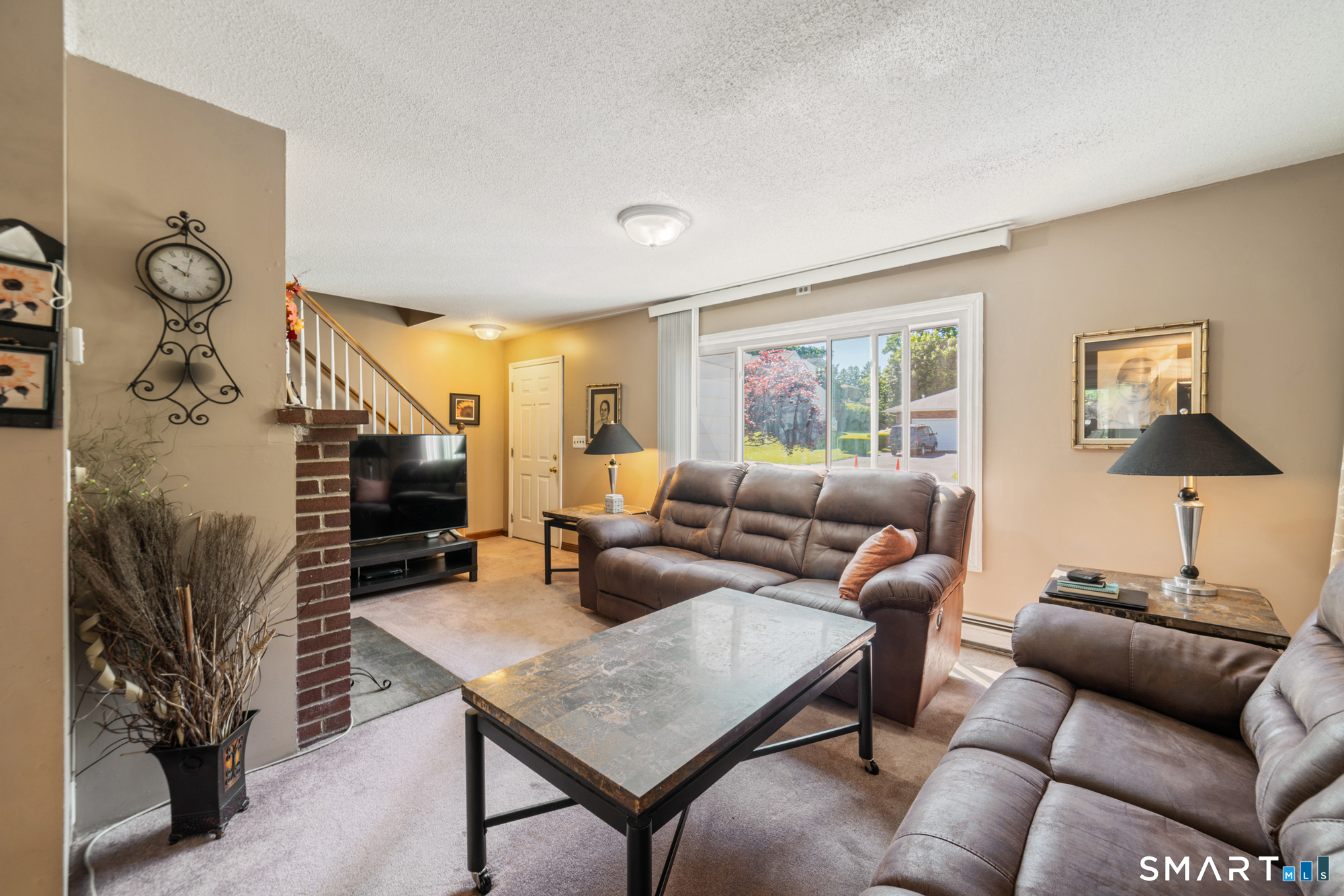 146 Highland Drive Waterbury, CT 06708 - Photo 5 of 31 a living room with furniture a flat screen tv and a fireplace