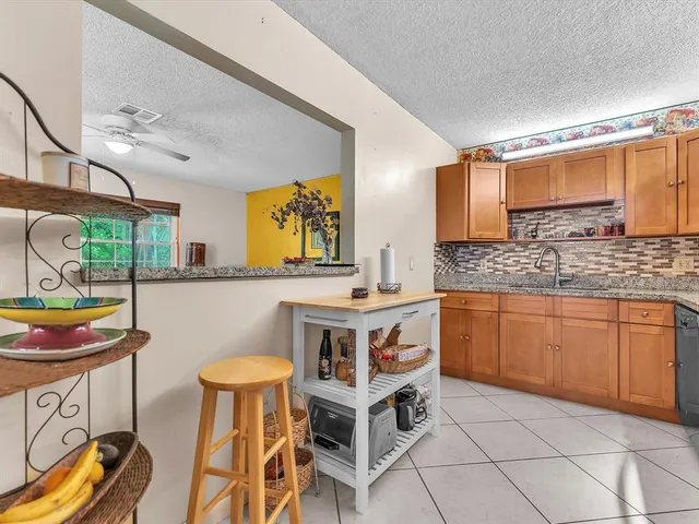 a kitchen with stainless steel appliances granite countertop a sink and a stove