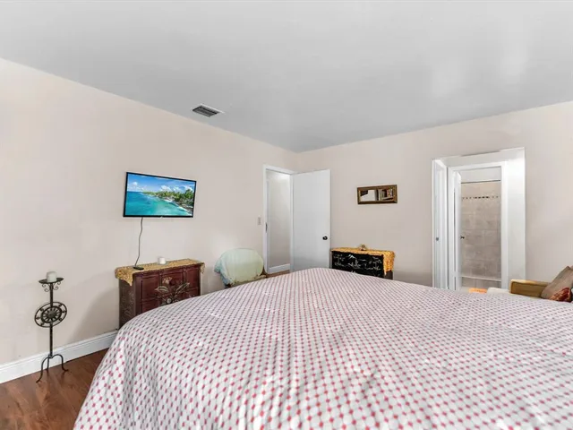 a bedroom with a bed and a lamp