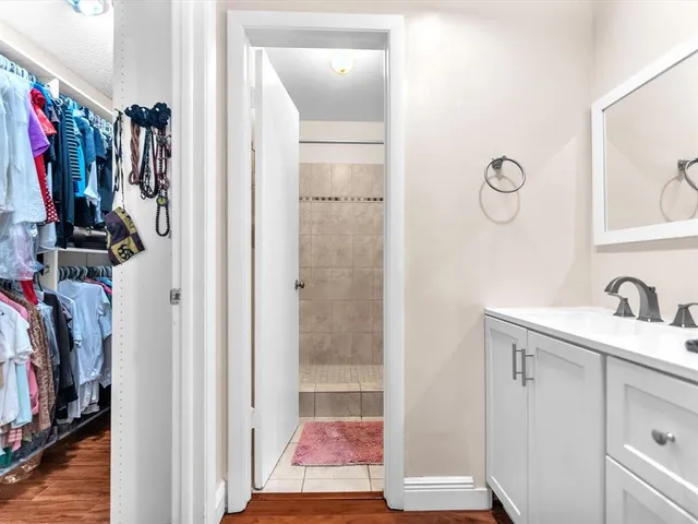 a view of walk in closet with clothes and shoes
