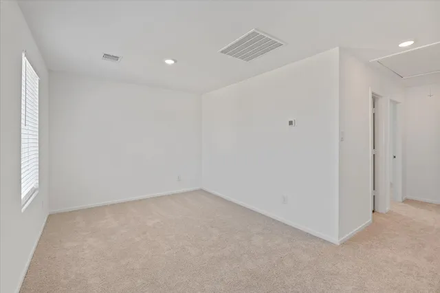 a view of an empty room with windows