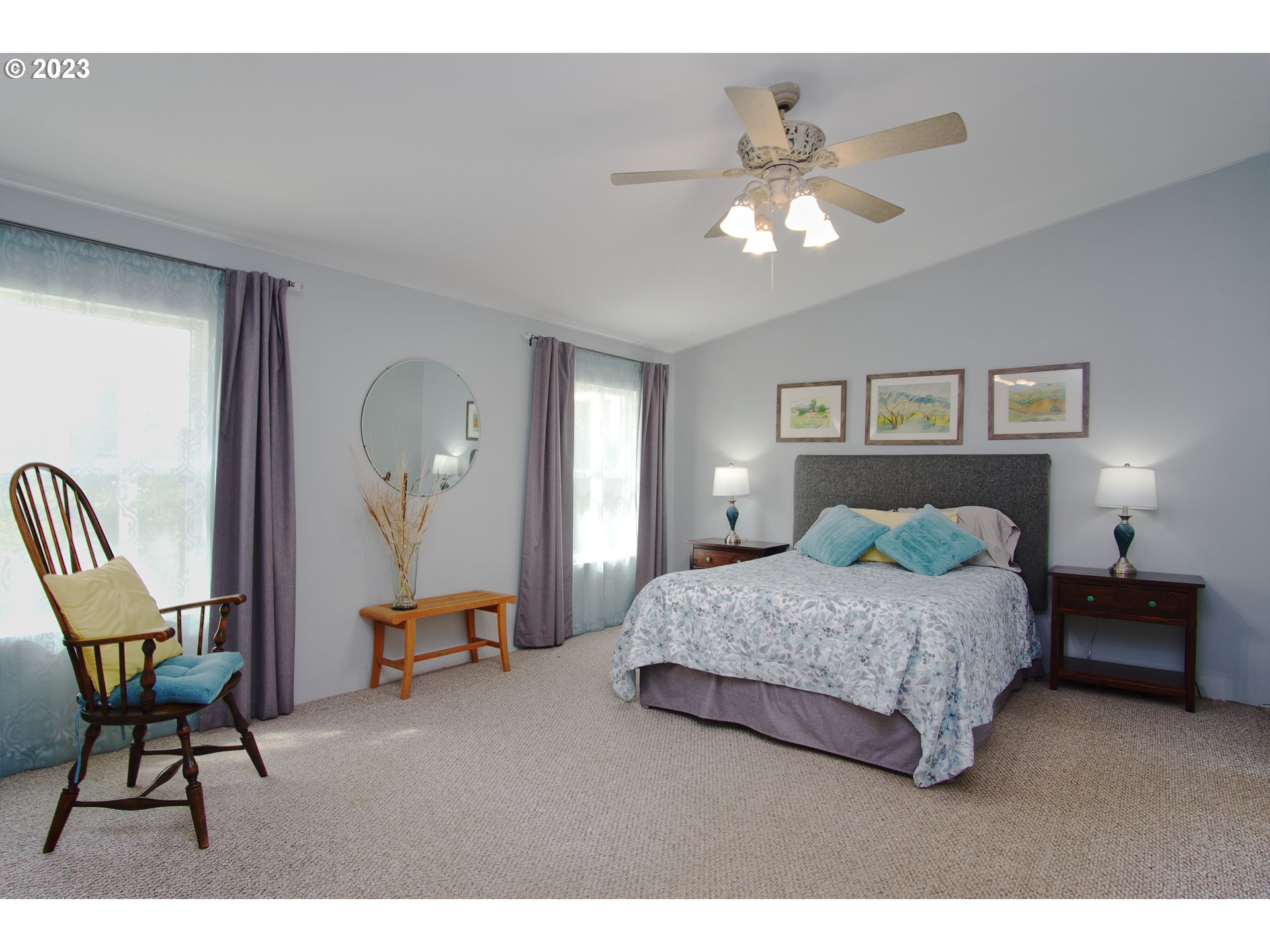 18950 South Ridge Road Oregon City, OR 97045 - Photo 11 of 27 a bedroom with a bed and a chandelier