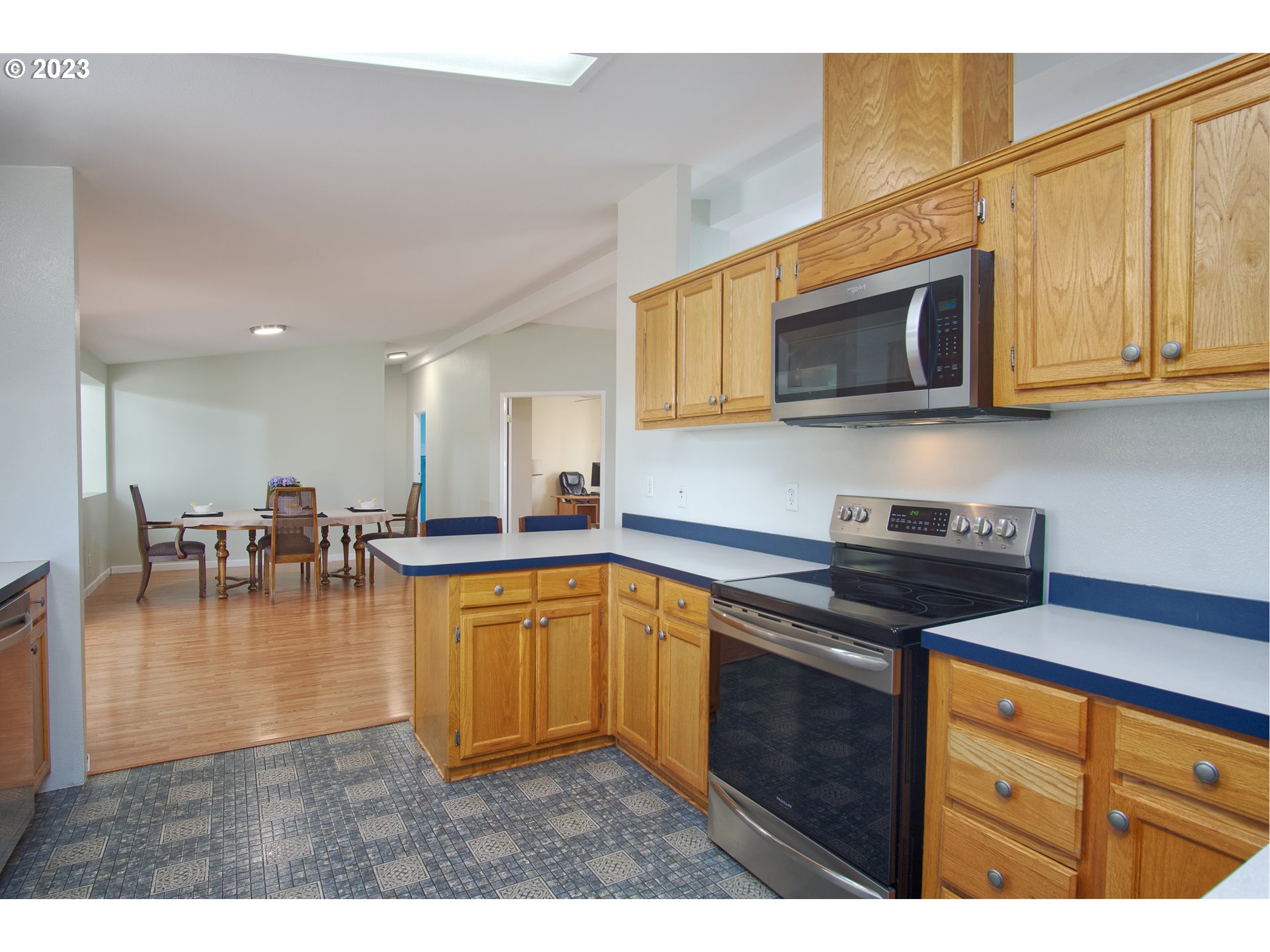 18950 South Ridge Road Oregon City, OR 97045 - Photo 8 of 27 a kitchen with stainless steel appliances granite countertop a stove a sink dishwasher and a microwave with wooden floor