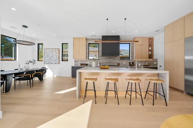 a kitchen with stainless steel appliances granite countertop a stove a sink and a refrigerator