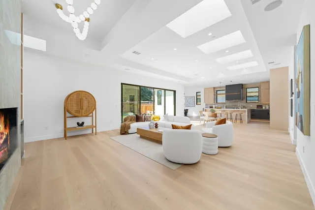 a living room with furniture a fireplace and a large window