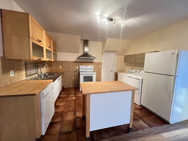 a kitchen with a refrigerator a sink and dishwasher