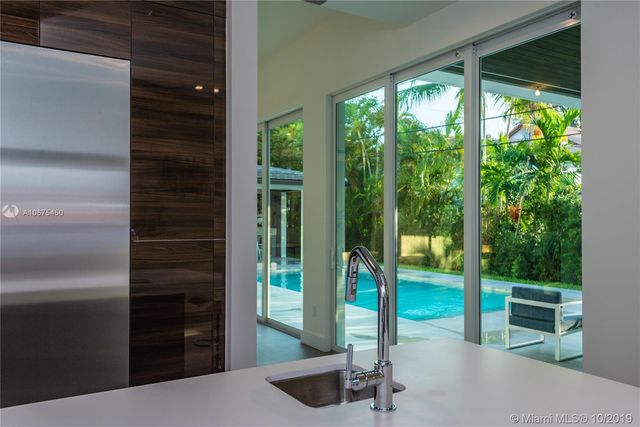 a living room with hardwood floor and a garden