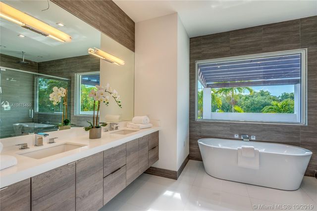a bathroom with a bathtub a sink and a window