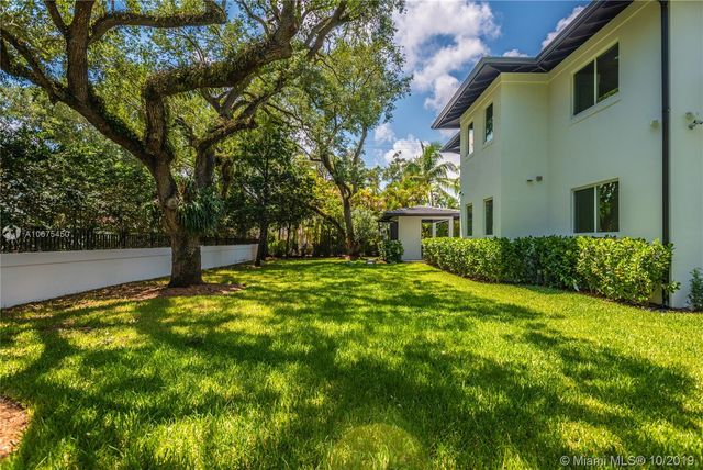 a view of backyard of house with green space