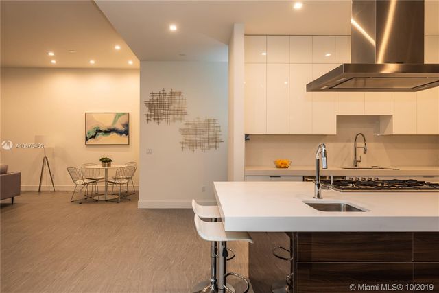 a kitchen with a sink cabinets and stove
