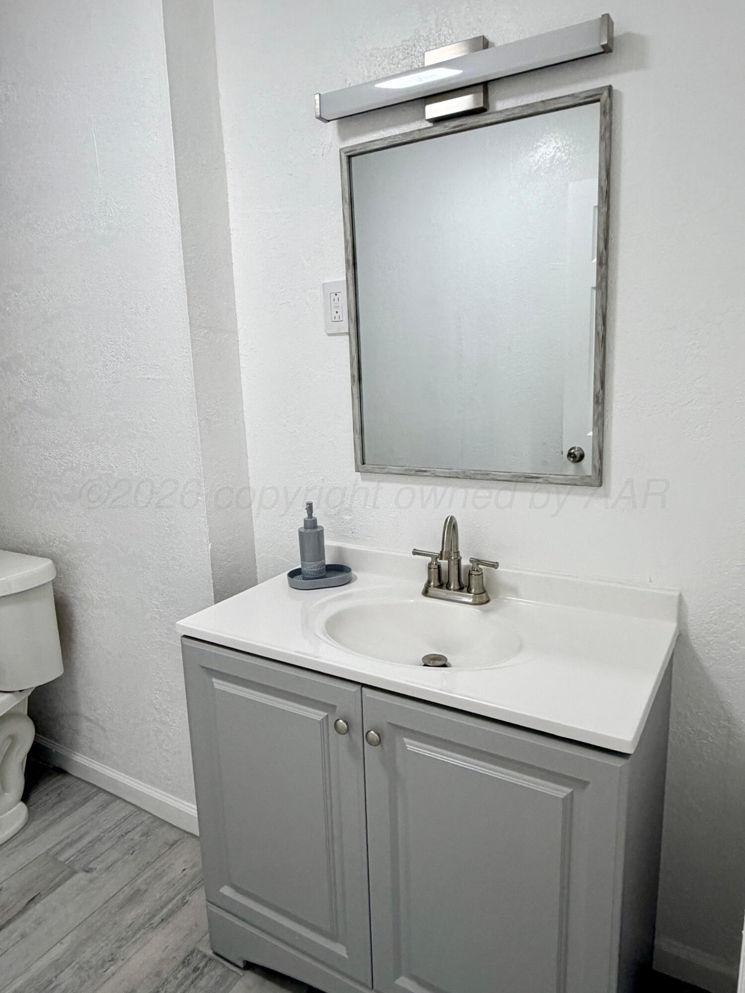 104 Warwick Street Borger, TX 79007 - Photo 18 of 28 a bathroom with a sink and a mirror