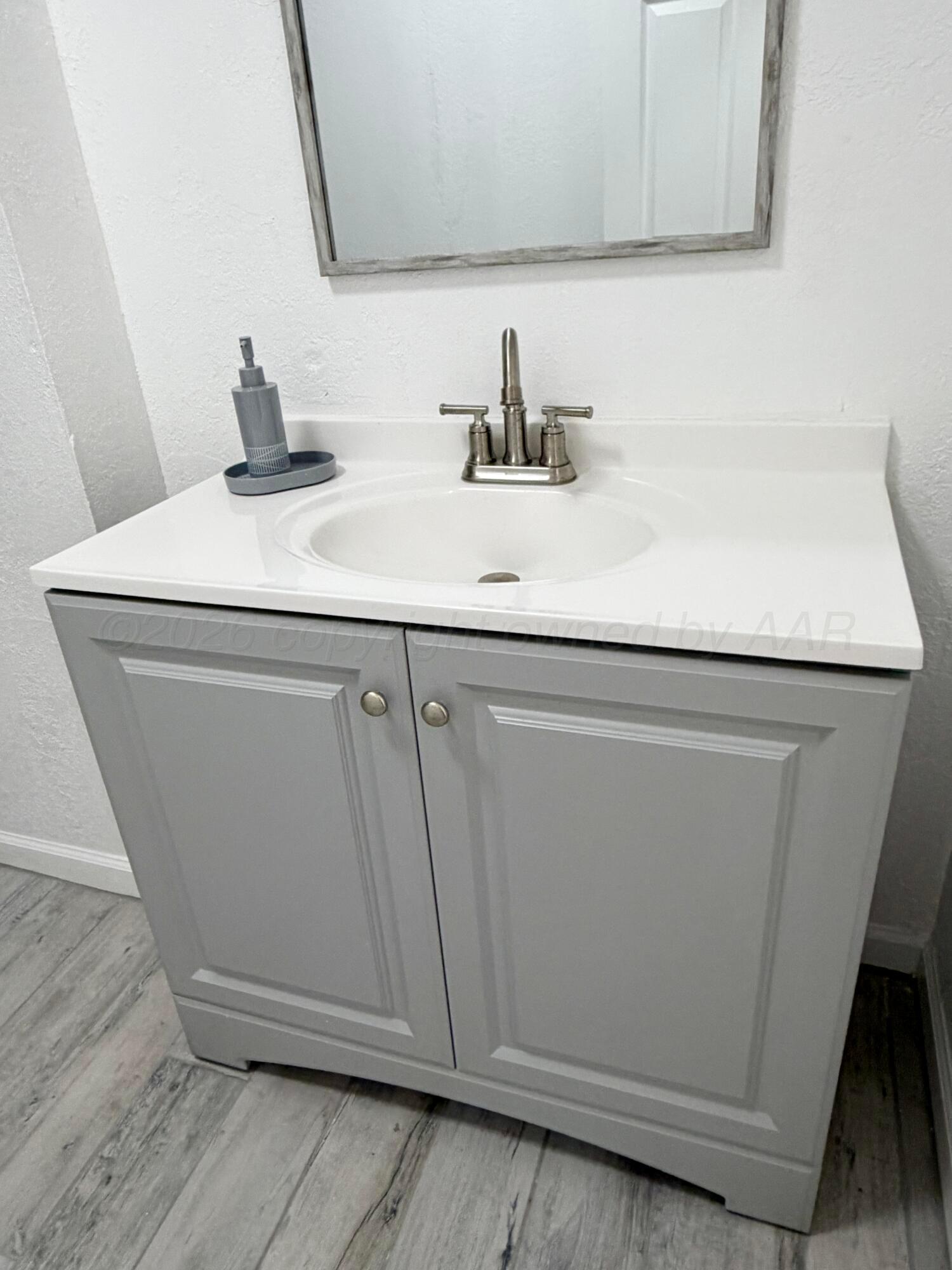 104 Warwick Street Borger, TX 79007 - Photo 19 of 28 a bathroom with a sink and a mirror