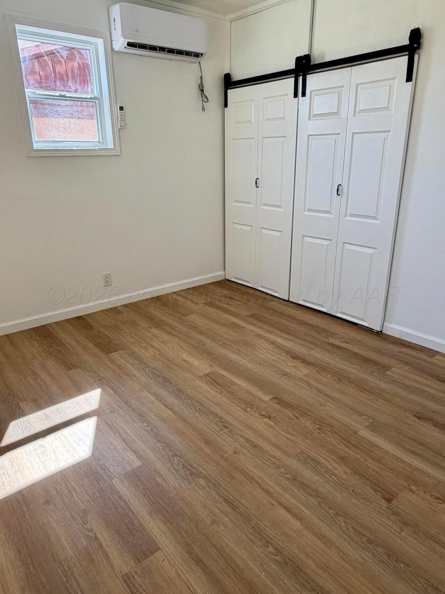 104 Warwick Street Borger, TX 79007 - Photo 24 of 28 a view of an empty room with wooden floor
