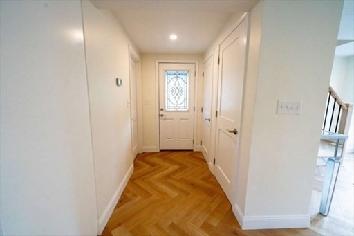 35 Wright Street Stoneham, MA 02180 - Photo 7 of 19 a view of a hallway with wooden floor and staircase