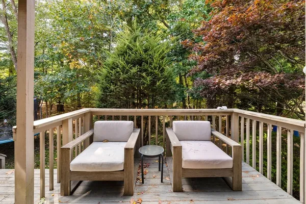a balcony with wooden floor and furniture