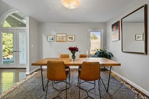 a dining room with furniture and window