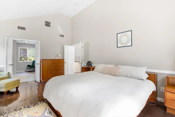 a bedroom with a bed and wooden floor