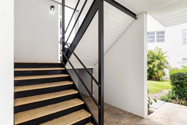 a view of entryway with wooden floor and stairs
