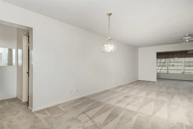 a view of empty room with ceiling fan