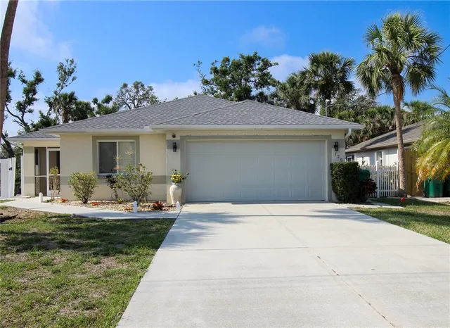 a front view of a house with porch and garden
