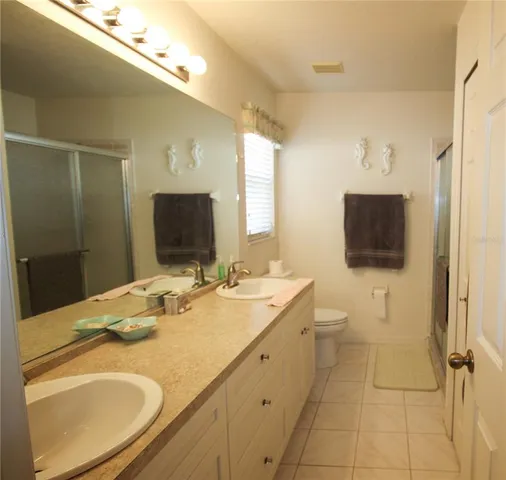a bathroom with a sink a large mirror and a shower