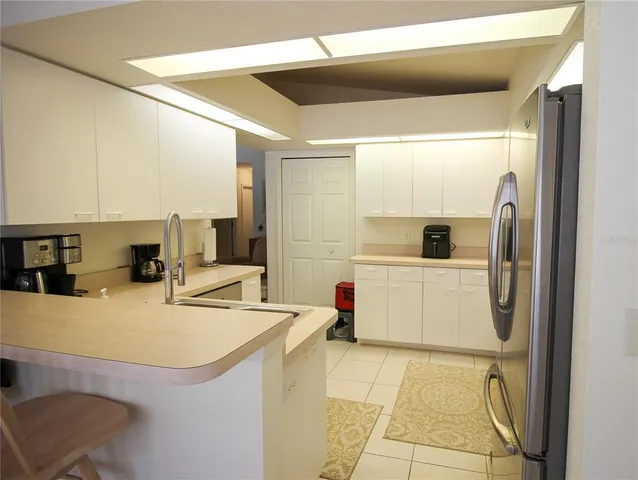 a kitchen with a sink a counter top space cabinets and appliances