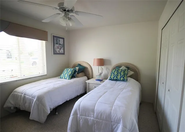 a bedroom with two beds and a chandelier