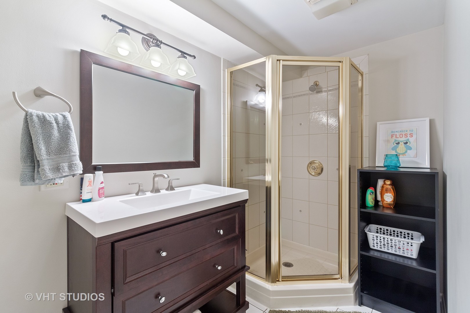 985 Chapel Court North Glen Ellyn, IL 60137 - Photo 22 of 39 a bathroom with a sink a mirror and a shower