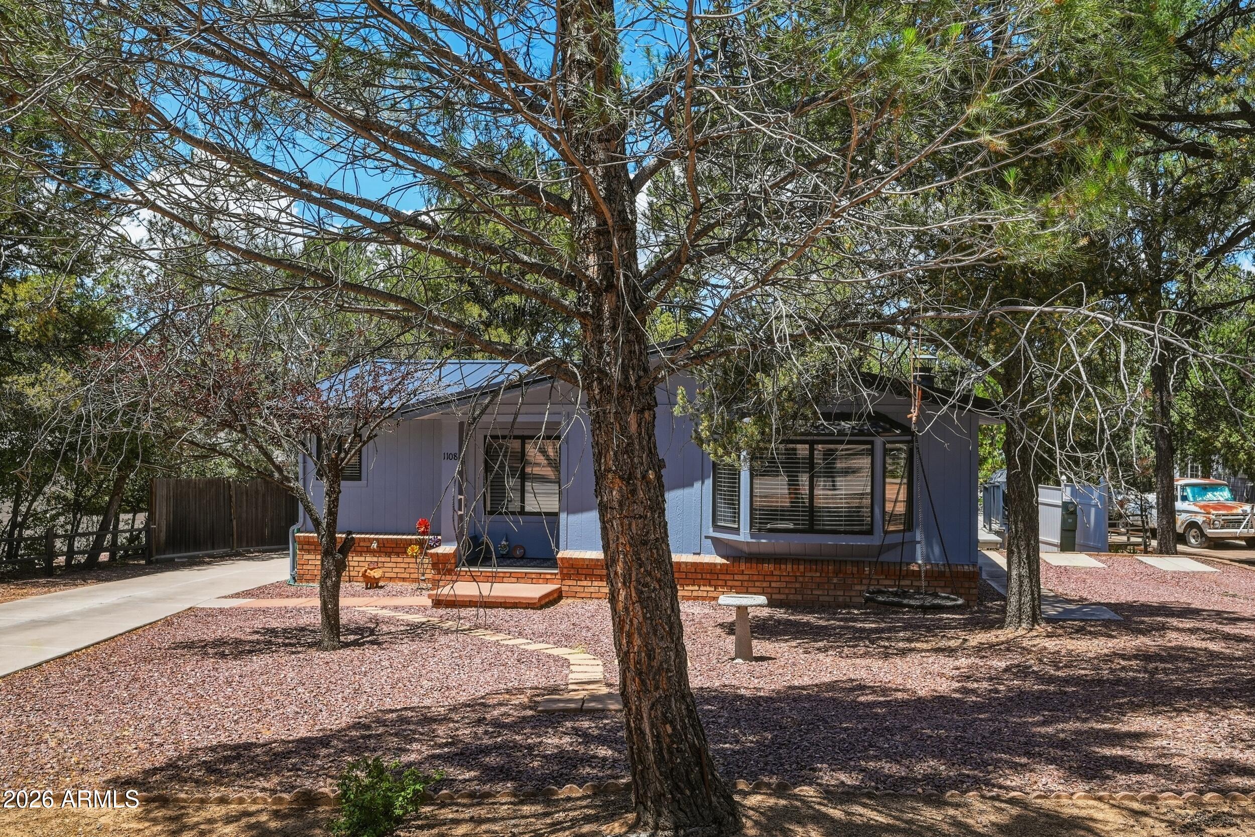 1108 North William Tell Circle Payson, AZ 85541 - Photo 4 of 32 a tree in the middle of a yard