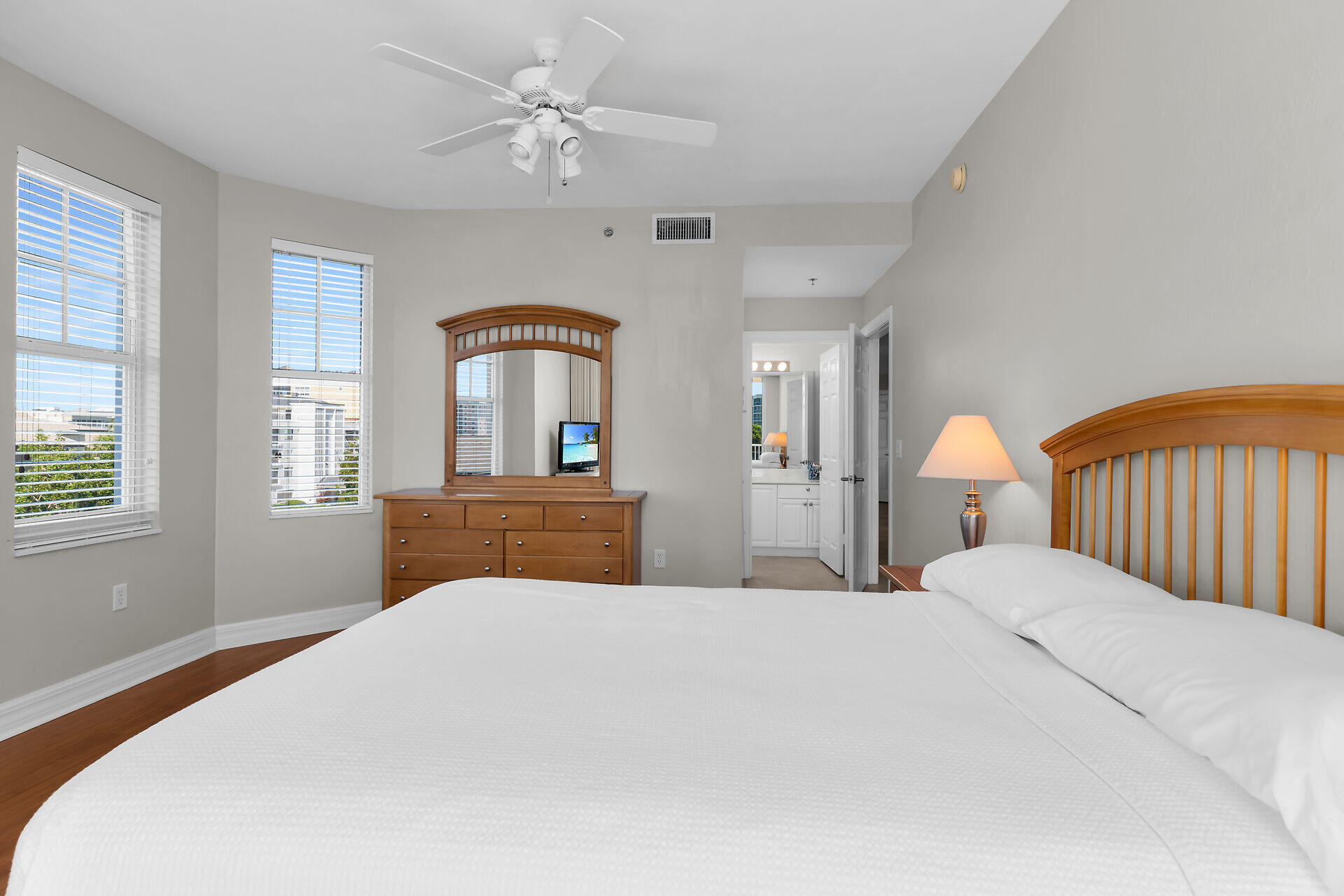 1111 Swallow Avenue, Unit 1401 Marco Island, FL 34145 - Photo 34 of 36 a bedroom with a large bed and a chandelier