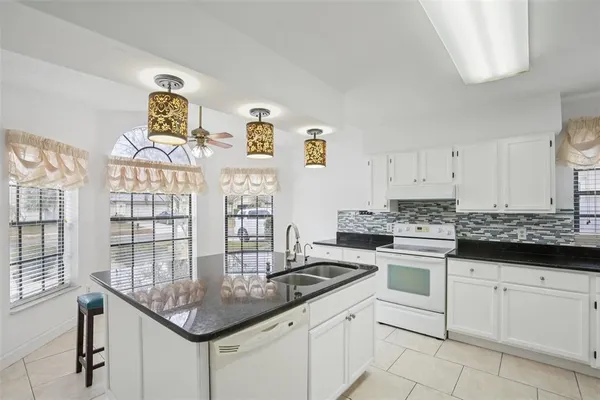 a kitchen with stainless steel appliances granite countertop a sink and cabinets