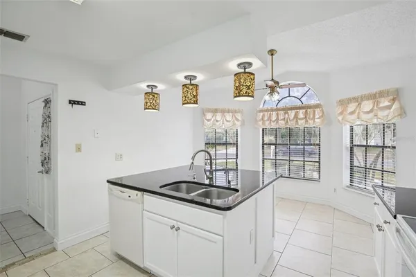 a kitchen with granite countertop a sink and a stove top oven