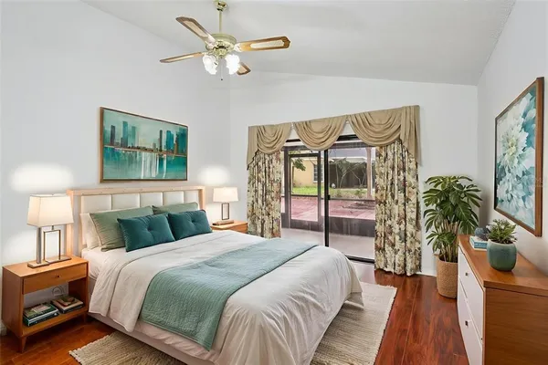 a bedroom with a large bed and a chandelier