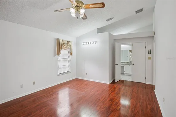 a view of empty room with wooden floor