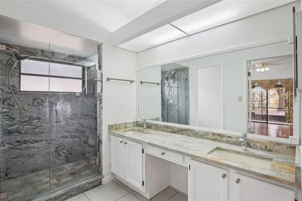 a bathroom with a granite countertop sink mirror and double