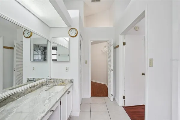 a large bathroom with a granite countertop tub sink and shower