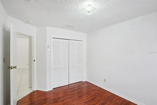a view of room with wooden floor