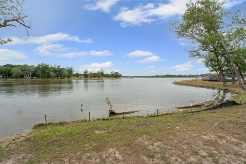 a view of a lake with houses in the background