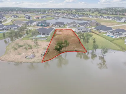an aerial view of a house with a lake view