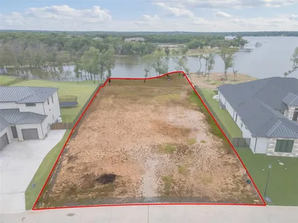 an aerial view of a house with a lake view