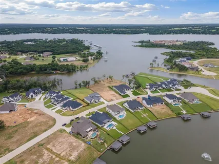 a view of a big house with a big yard and large trees