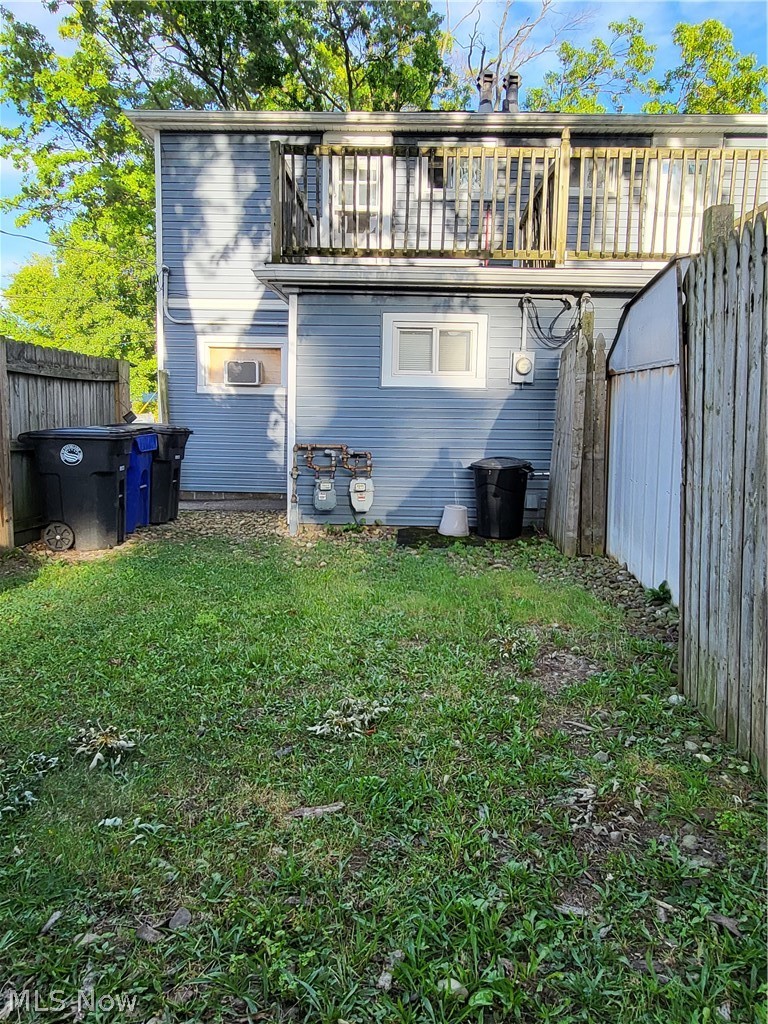 View of the home from the backyard. You can see the second story balcony.