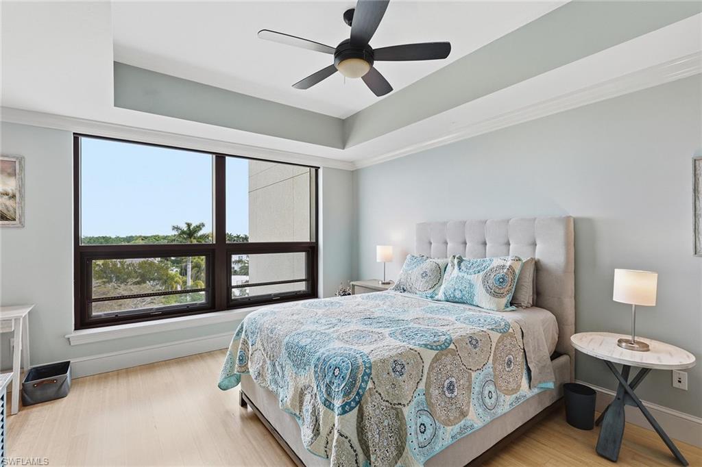 9123 Strada Place, Unit 7409 Naples, FL 34108 - Photo 11 of 34 a bedroom with a large bed and a large window