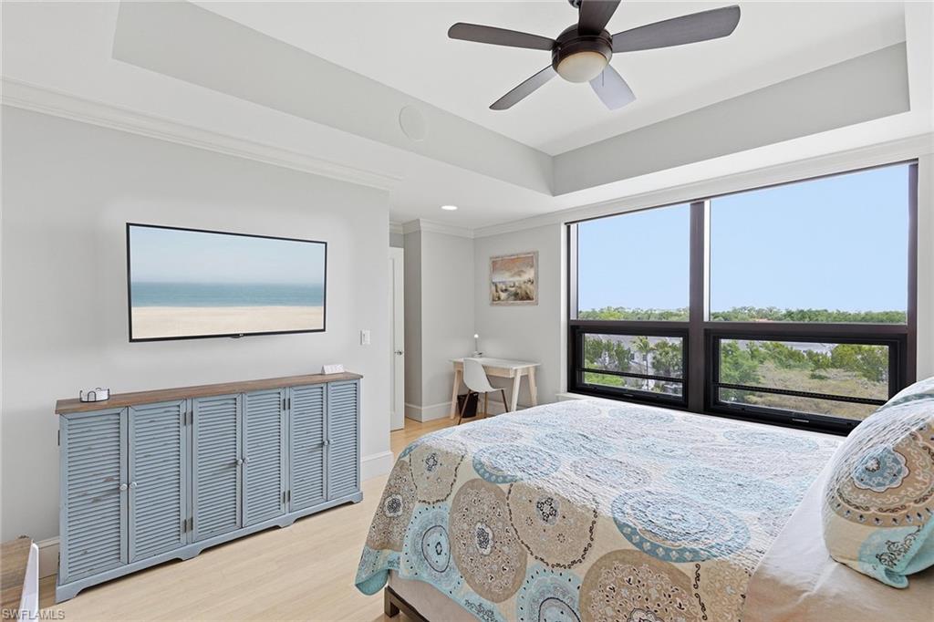 9123 Strada Place, Unit 7409 Naples, FL 34108 - Photo 12 of 34 a bedroom with a large bed and a large window