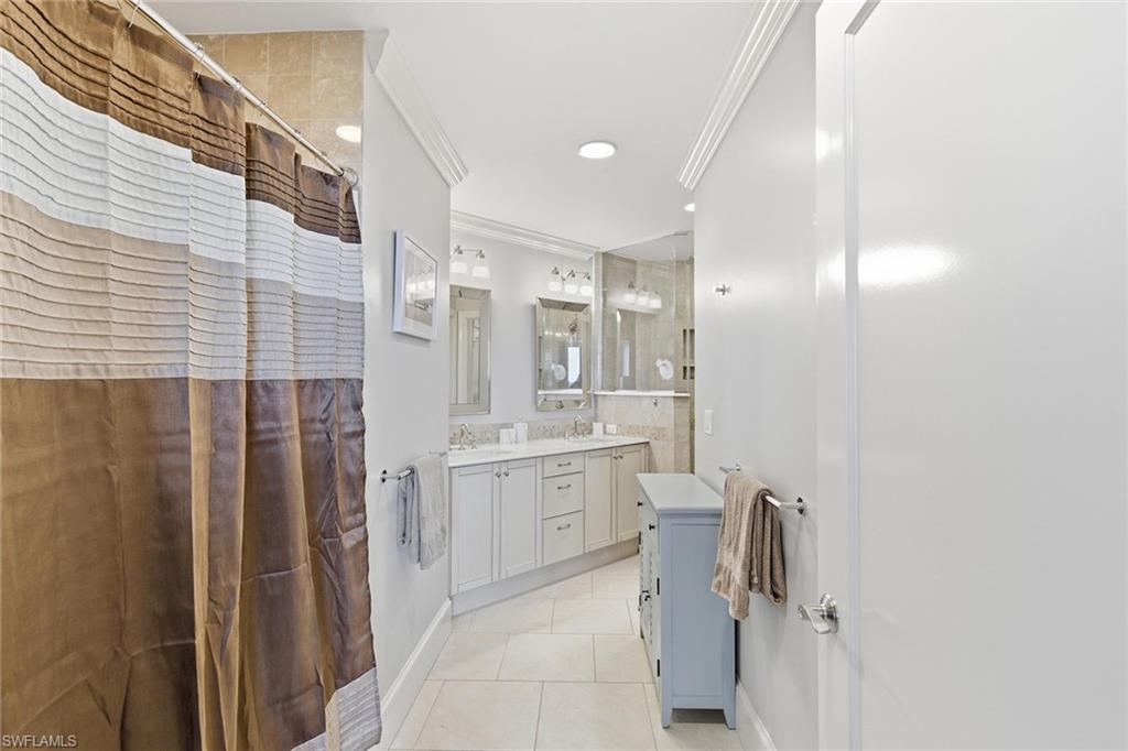9123 Strada Place, Unit 7409 Naples, FL 34108 - Photo 13 of 34 a large bathroom with a granite countertop sink mirror and shower