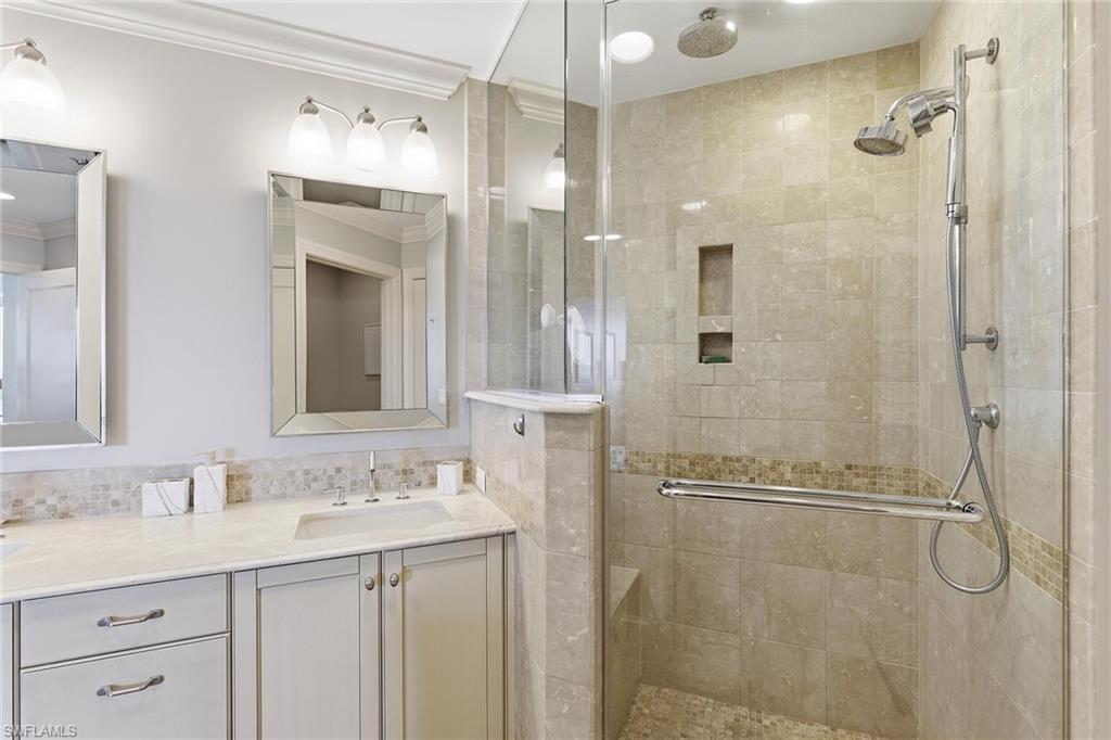 9123 Strada Place, Unit 7409 Naples, FL 34108 - Photo 14 of 34 a bathroom with a granite countertop shower sink vanity and mirror