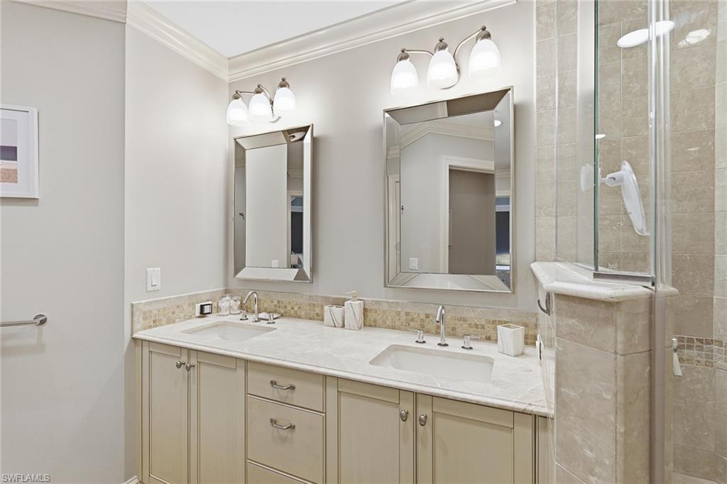 9123 Strada Place, Unit 7409 Naples, FL 34108 - Photo 15 of 34 a bathroom with a double vanity sink and a mirror