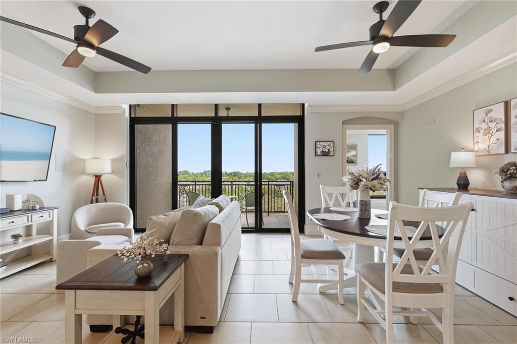 9123 Strada Place, Unit 7409 Naples, FL 34108 - Photo 2 of 34 a living room with furniture and a large window